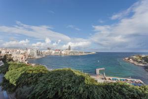 a view of a city and the ocean with buildings at Plaza Regency Hotels in Sliema