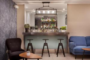 a bar with two chairs and a blue bar at Plaza Regency Hotels in Sliema