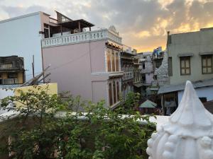 a white building in the middle of a city at French Haveli in Ahmedabad