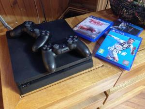 a table with two video game controllers and a dvd at Wooden Attic Suite in Braşov