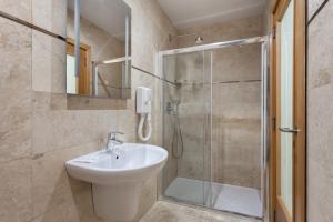 a bathroom with a sink and a shower at Plaza Regency Hotels in Sliema