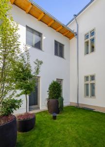a house with a large window and plants in the yard at Adele Boutique Hotel in Pécs