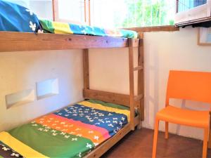 a bunk bed with a ladder and a chair in a room at Cirici in Lloret de Mar