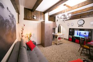 a living room with a couch and a tv at Spacious Apartment Next To Metro - Marousi in Athens