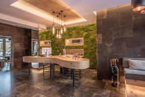 a dining room with a table and a green wall at Bavaria Boutique Hotel in Munich