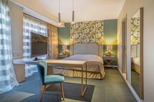 A bed or beds in a room at Airotel Stratos Vassilikos Hotel