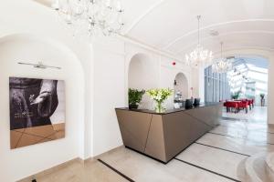 a large room with a large vase filled with flowers at Adele Boutique Hotel in Pécs