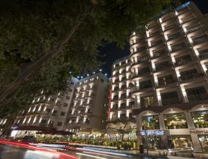 a building at night with a street in front of it at Plaza Regency Hotels in Sliema