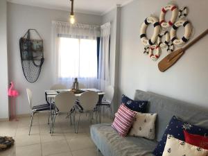 - un salon avec un canapé et une table avec des chaises dans l'établissement Alicante hills - apartment Gilda, à Alicante