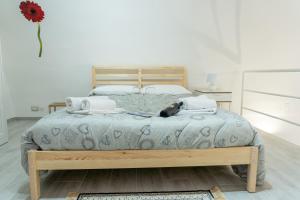 a bedroom with a large bed with a wooden frame at Il Sassetto in Matera