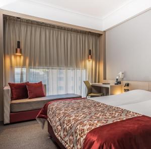 A bed or beds in a room at Airotel Stratos Vassilikos Hotel