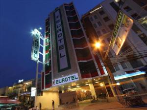 a building with a sign for a hotel at night at Eurotel Angeles in Angeles