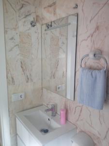 a bathroom with a sink and a mirror at APARTAMENTO PUERTA SEVILLA in Carmona +38 photos