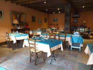 a dining room with blue tables and chairs at Hôtel le Lion d'Or Hotel Autonome in Salbris