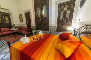 a bedroom with a bed with stuffed animals on it at Riad Hala in Fez