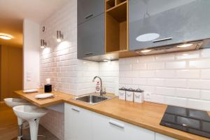 a kitchen with a sink and a toilet at Apartment Platinium I in Białystok