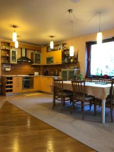 a kitchen with a table and chairs in a room at Ambrozia Spa and Relax family house in Bachkovo