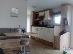 a kitchen and living room with a table and a couch at Mobilheime in Klaffer am Hochficht