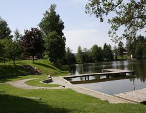 a person sitting on the steps by a river at Mobilheime in Klaffer am Hochficht