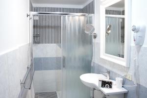 a bathroom with a sink and a shower at Vittoria Guest House Salerno in Salerno +44 photos