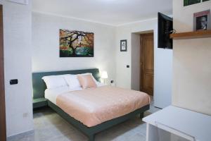 a bedroom with a bed and a painting on the wall at Vittoria Guest House Salerno in Salerno