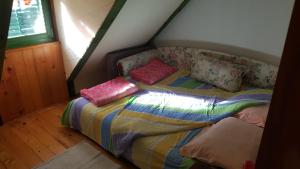 a bed with pillows on it in a room at GreenPointMountainHouse for 6 persons in Kopaonik
