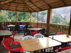 a group of tables and chairs in a restaurant at Posada Gloria in Tapay