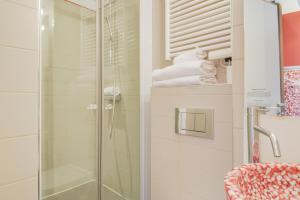 a shower with a glass door in a bathroom at Pavillon Nation in Paris +27 photos