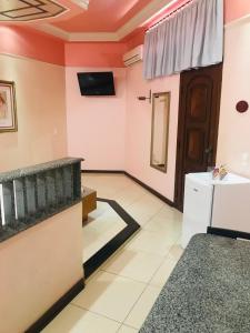 a living room with a television and a door at Euro Motel (Only Adults) in Viracopos