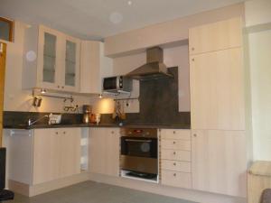 a kitchen with white cabinets and a stove at Zimmer Frei in Wiesbaden