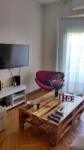 a living room with a coffee table and a flat screen tv at Apartamento en Palermo, Argentina in Buenos Aires