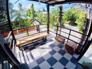 a balcony with benches and a view of a street at The Endless Bangtao Residence LOFT 7 in Bang Tao Beach