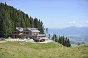 a large house on top of a hill at BöckLodges in Nesselwang
