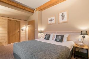 a bedroom with a large bed and a desk with a lamp at Hotel Foluszowy Potok in Zakopane