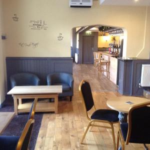 a living room filled with furniture and a large window at The Bear On The Square in Millom