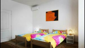 2 letti singoli in una camera da letto con una foto appesa al muro di Beograd Admiral Apartments a Belgrado 1 altra foto