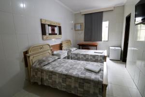 Krevet ili kreveti u jedinici u okviru objekta Charme Hotel Guarujá Frente Mar