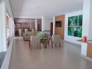 a living room with a couch and a table and chairs at Cyrilo's Palace Hotel in Capitólio