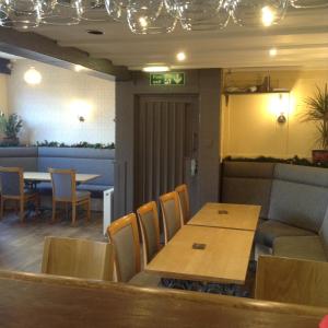 a dining room with a table and chairs at The Bear On The Square in Millom