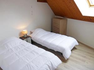 a bedroom with two beds and a lamp on a table at Apartment La Borgia A- B- C-10 by Interhome in Les Contamines-Montjoie