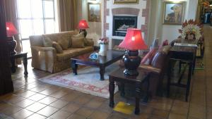 a living room with a couch and a table with a lamp at Peermont Metcourt at Frontier, Bethlehem in Bethlehem