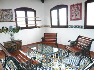 a room with two benches and a glass table at Holiday Home Les Ecuries by Interhome in Alet-les-Bains