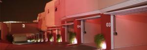 a row of red buildings with plants on the fronts at Euro Motel (Only Adults) in Viracopos