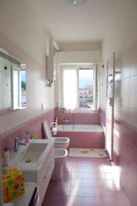 a bathroom with a tub and a toilet and a sink at Rebecca House in La Spezia