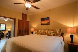 a bedroom with a bed and a ceiling fan at X'tan Ha- The Waterfront in San Pedro