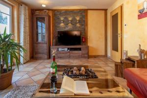 a living room with a bottle of wine and a book at Wildnisresidenz am Nationalpark in Lindberg