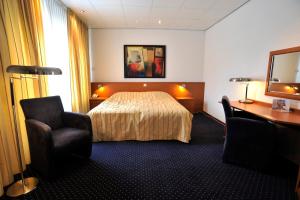 Postel nebo postele na pokoji v ubytování City Hotel Bergen op Zoom