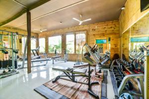 a gym with several treadmills and exercise bikes at Brushwood Villa Resort in Palolem