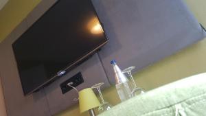 a flat screen tv on a wall above a bathroom sink at myHome in Gießen