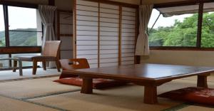 a living room with a wooden table and a window at Kami - Hotel / Vacation STAY 15951 in Kami